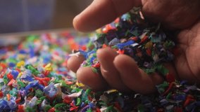 colorful plastic fragments close up, plastic waste, plastic pollution, environment. microplastics in hands. pieces of microplastic in the world's oceans. plastic recycling concept - Powered by Shutterstock - Get 15% off with code: PIKWIZARD15