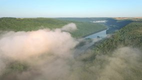 In the morning a thick fog spreads through the Dniester Canyon National Park from a bird's eye view. Location place Ukraine, Europe. Aerial footage, cinematic shot. Filmed UHD 4k video. Beauty earth.