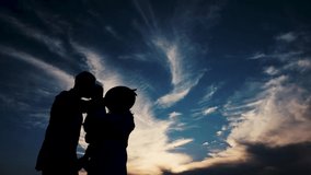 A charming video of a happy family against the background of the evening sky. 