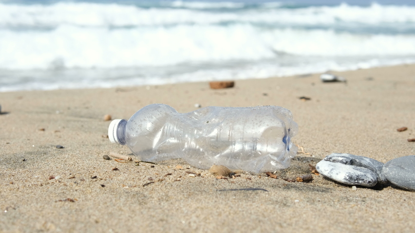 Used Plastic bottle discarded on sea shore ecosystem,environment waste pollution | Shutterstock HD Video #1095082501