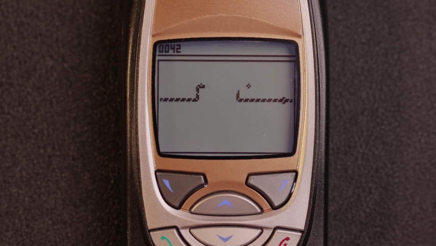 Playing snake game on an old mobile phone Royalty-Free Stock Footage #1095086153