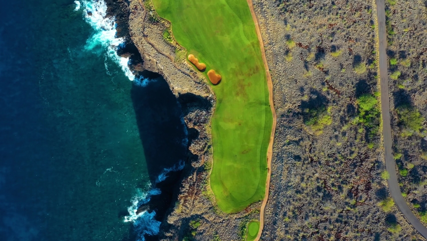 Breathtaking Manele Golf Course on precipitous sea cliffs, Lanai; drone top down