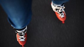 The woman is rollerblading on the road. Slow motion video on rollers. orange rollers
