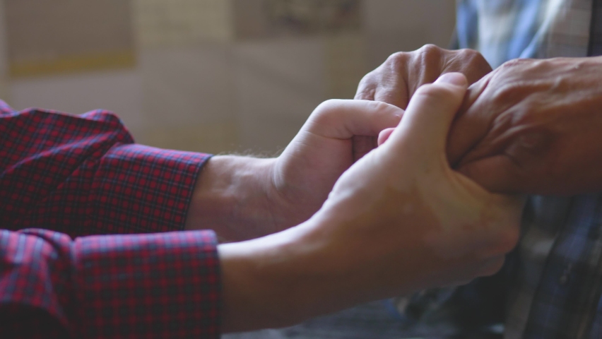 in the hands of an adult son, the hands of an elderly father, parental care, guardianship of the elderly. son with a retired father friendship. family emotions. Royalty-Free Stock Footage #1095099357