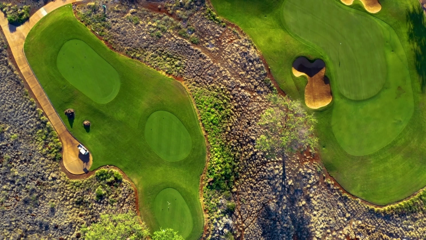 Twisting aerial top down riser above Manele Golf Course, Lanai, Hawaii