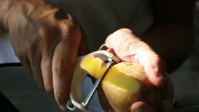 Female Adult Woman Hands Peeling a Potato Close Up 