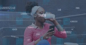 Animation of changing numbers over african american woman drinking coffee and using smartphone. Social media networking technology concept