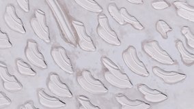 Aerial view of the shrinking Dead Sea. 4k video. Lifeless beautiful desert patterns. Video light background.