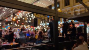 Night city life with a band playing and people dancing and partying - Defocused image with bokeh - Powered by Shutterstock - Get 15% off with code: PIKWIZARD15