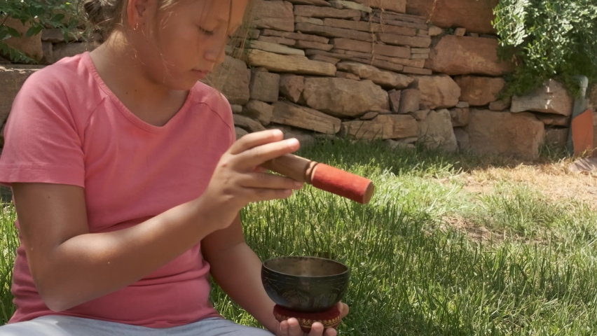 a girl with Tibetan bowl