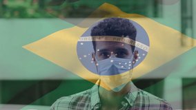 Animation of flag of brazil waving over laitn man wearing face mask in city street. global health precautions during covid 19 pandemic concept digitally generated video.