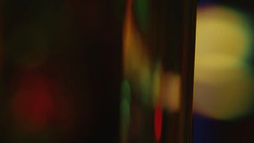 Close up shot of blurred bokeh lights refracted through glass prism turning in darkness - Powered by Shutterstock - Get 15% off with code: PIKWIZARD15