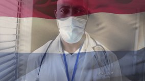Animation of flag of netherlands waving over doctor wearing face mask. global medicine, healthcare services during covid 19 pandemic concept digitally generated video.