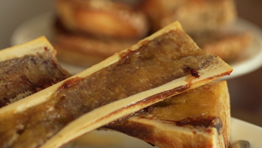 4K tasty food video. Close up view of a dish with beef marrow in its own bone. Royalty-Free Stock Footage #1095128081