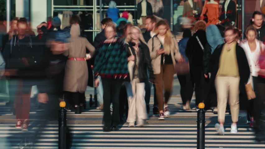 Time-lapse unrecognizable people crowd crossing city street, busy crossroad, pedestrians crossing crosswalk intersection, car traffic. Timelapse rush hour crowded people walk, daylight, fast motion