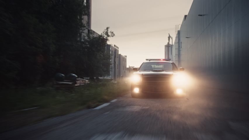 Traffic Patrol Car in Pursuit. Police Officers in Squad Car Chasing Suspect on Industrial Road, Sirens Blazing, High Speed. Cops on Emergency Response Call. Stylish Cinematic Action Packed Shot | Shutterstock HD Video #1095135017