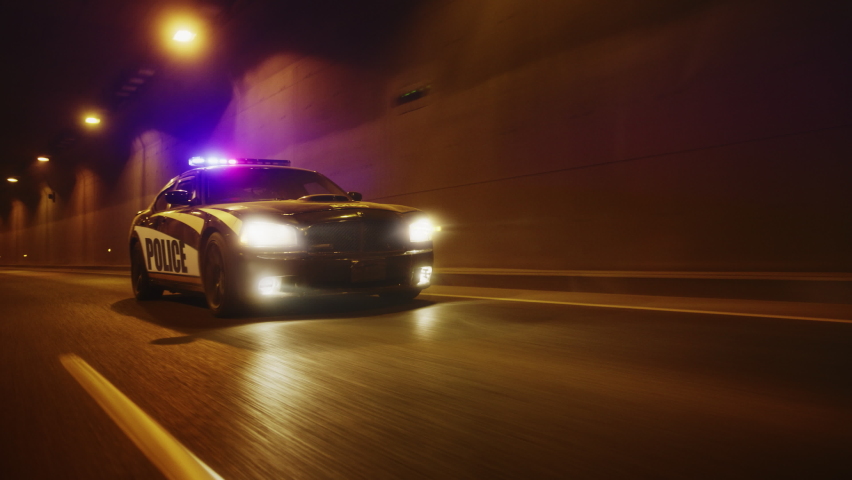 Traffic Patrol Car In Pursuit, Driving Fast with Sirens Blazing through the City Tunnel. Officers of the Law Chasing a Suspect. Cops in Squad Car React to Emergency Call. Cinematic Night Shot | Shutterstock HD Video #1095135023