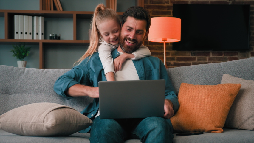 Active little child need parental attention disturb dad from working on laptop male adult freelancer single young man parent chatting online use internet at home hug noisy daughter calm adorable kid - Powered by Shutterstock - Get 15% off with code: PIKWIZARD15