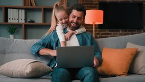 Active little child need parental attention disturb dad from working on laptop male adult freelancer single young man parent chatting online use internet at home hug noisy daughter calm adorable kid - Powered by Shutterstock - Get 15% off with code: PIKWIZARD15