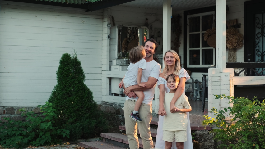 Happy caucasian family are standing near the house. Royalty-Free Stock Footage #1095147435