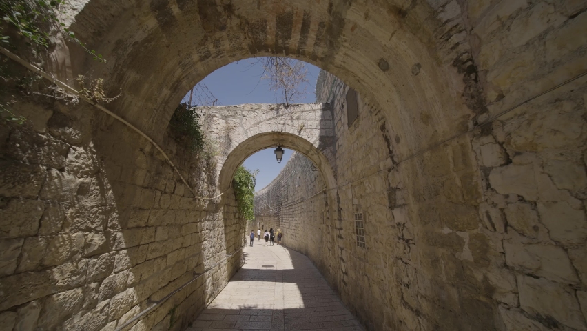 People Walking Through Stone Archway Within The Western Wall In Old City Of Jerusalem In Israel. - POV Royalty-Free Stock Footage #1095151777