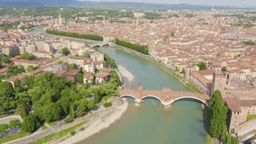Inscription on video. Verona, Italy. Flying over the historic city center. Scaliger Bridge. Castelvecchio Castello Scaligero, summer. Knitted texture inscription, Aerial View, Departure of the camera