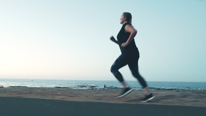 Fitness, workout and running with woman at the beach for weight loss, health and motivation in Miami city. Sports, exercise and training with plus size runner in the morning for wellness and summer