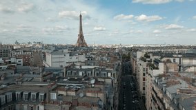 Drone flying over Paris roofs with Tour Eiffel in background, Paris. Aerial sideways