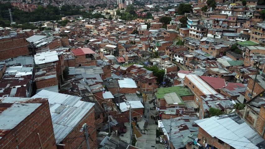 Medellin, Colombia, drone aerial view of Comuna 13 slums, favela. Once one of the most dangerous neighborhoods in world, Comuna 13 has reinvented itself in recent times and now is considered safe  | Shutterstock HD Video #1095174123
