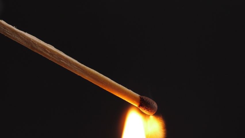 Light a match in the dark, closeup. Strike a matchstick
