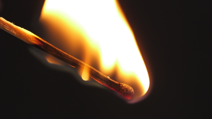 Light a match in the dark, closeup. Strike a matchstick