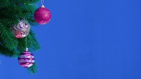 On a blue background, a branch with Christmas decorations chroma key