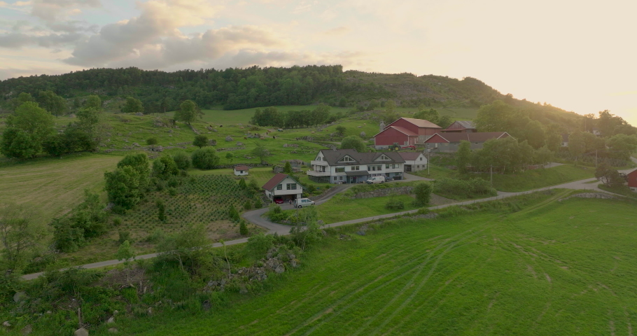 Amazing Sunset over farm on a hill. Golden hour, beautiful mountains.