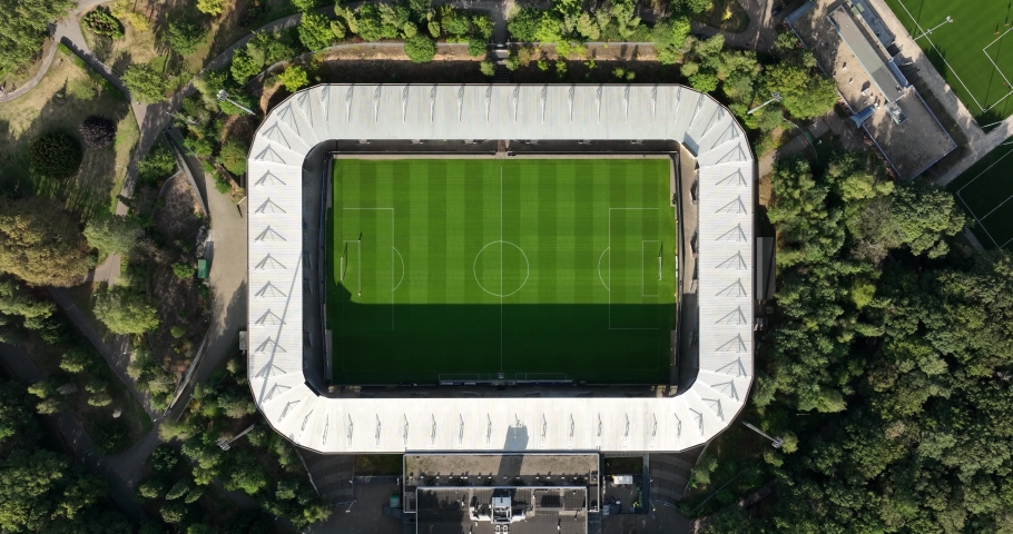 Soccer football stadium top down overhead Aerial in forrest park. Green grass landmark landscape architecture structure stands proffesional football club.