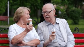 Elderly couple eating ice cream on a park bench. - Powered by Shutterstock - Get 15% off with code: PIKWIZARD15