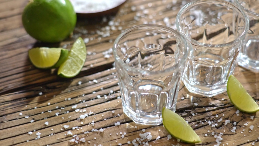 Pouring several glasses of Mexican Mezcal or Tequila shots.
Classic Tequila small glasses being served. | Shutterstock HD Video #1095184173