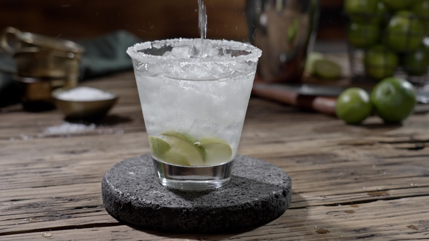 Pouring a freshly prepared Tequila Margarita glass.
Classic Margarita cocktail served chilled.

 Royalty-Free Stock Footage #1095184181