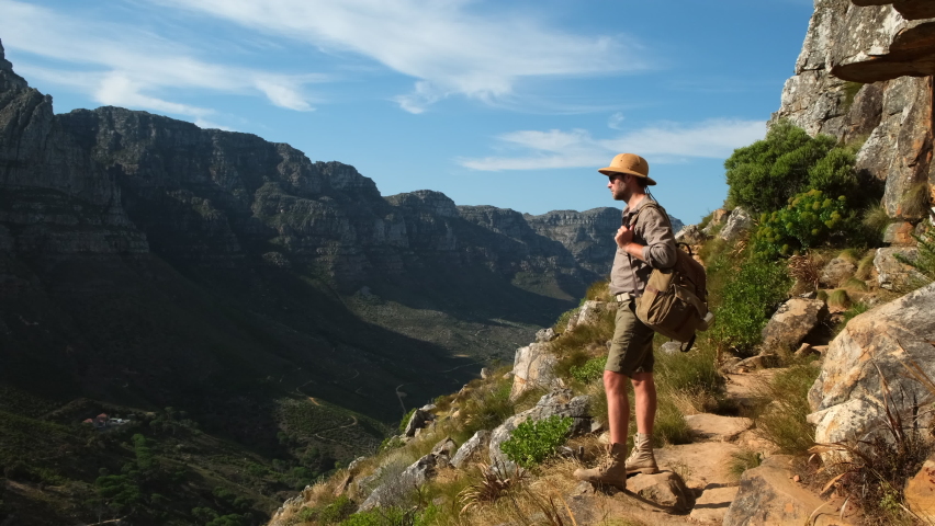 Landscape with Table mountain at sunrise. Cape Town South Africa, overlooking Table Mountain and Lions Head. a male traveler stands on the peak of a lion