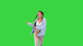 Pretty cheerful girl walking and doing dancing moves on a Green Screen, Chroma Key. - Powered by Shutterstock - Get 15% off with code: PIKWIZARD15