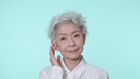 Elderly Asian woman. Green background for chroma key composition.