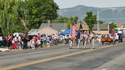 MORONI, UTAH - JULY 4TH 2015: Members of the Utah National Guard parade the US Flag and the Utah state flag during the annual Fourth of July parade in a small rural town.