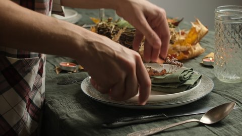 Thanksgiving celebratory supper. Woman setting a table for Thanksgiving day. Holiday feast.  Stockvideó