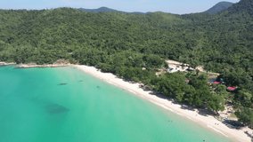 Aerial video of the beach, ocean with mountains in Thailand.