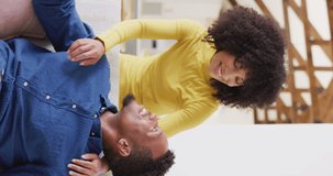 Vertical video of portrait of happy african american couple. Spending quality time at home together concept.