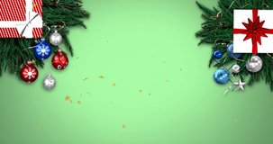 Animation of merry christmas text over baubles. Christmas, celebration and digital interface concept digitally generated video.