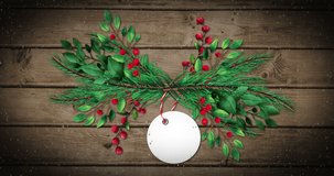Animation of snow falling and gift tag with copy space and tree branches on wooden background. Christmas, tradition and celebration concept digitally generated video.