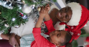 Vertical video of happy african american family having christmas time. Spending quality time with family at christmas concept.