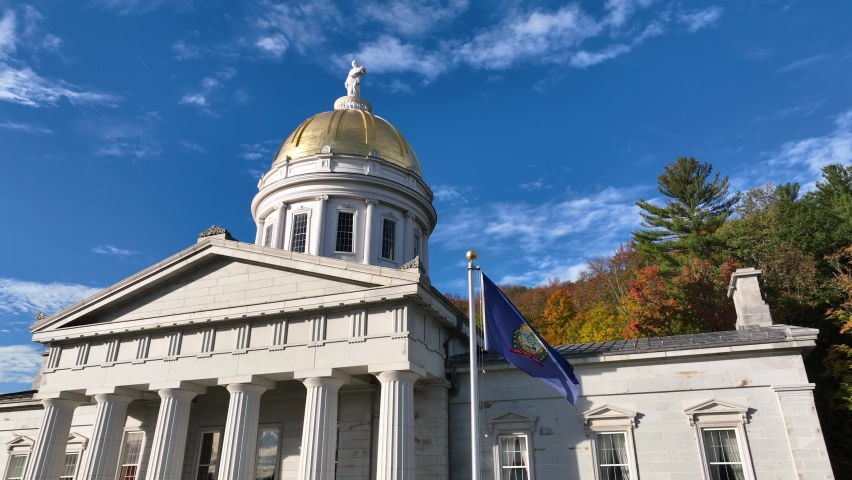 View of the Vermont State House in Montpelier, VT. Blue sky and autumn colors surrounding Capitol.