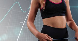 Animation of midsection of fit caucasian woman with measure over graphs on grey background. Fitness, diet, healthy lifestyle concept digitally generated video.