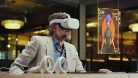 Middle aged man with VR headset communicates with virtual character avatar in the metaverse platforms. Technology of digital world in parallel with the physical one in the future concept.